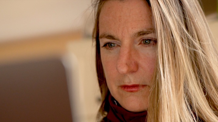 Close-up of a woman looking intently at a computer screen